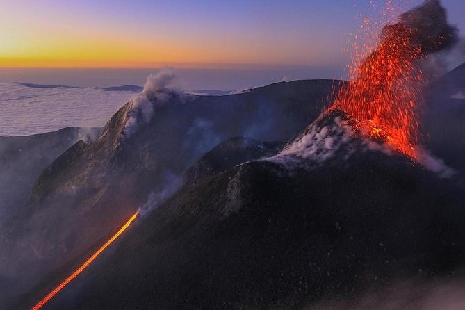 Sunset Trekking on Mount Etna - Entering a lava-flow cave with helmet and torch